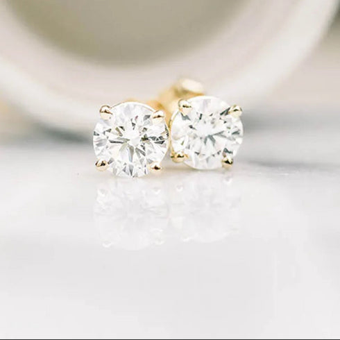 Pair of diamond stud earrings on a light background