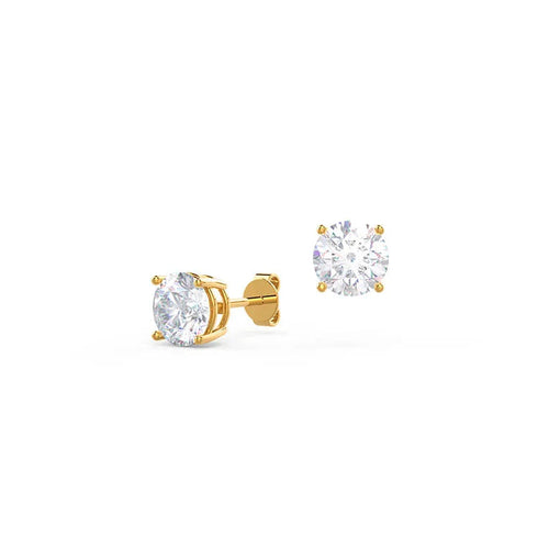 Gold stud earrings with clear gemstones on a white background